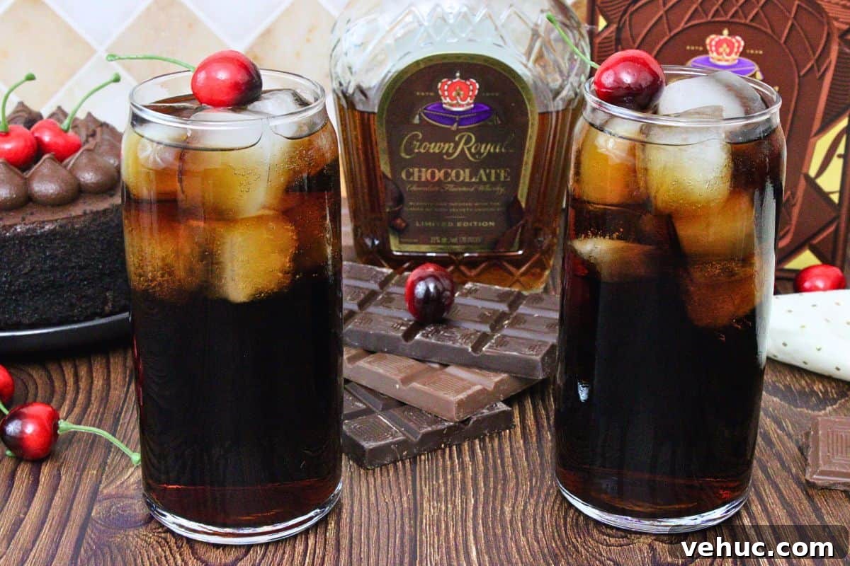12 Irresistible Chocolate Crown Royal Cocktails to Try Tonight 14 two crown royal chocolate and cherry coke drinks garnished with cherry in front of crown bottle