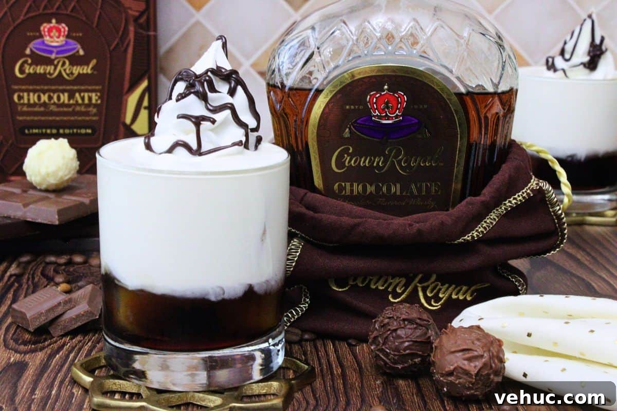 12 Irresistible Chocolate Crown Royal Cocktails to Try Tonight 4 crown royal chocolate white russian with whipped cream and chocolate drizzle next to new whisky bottle and chocolate truffles