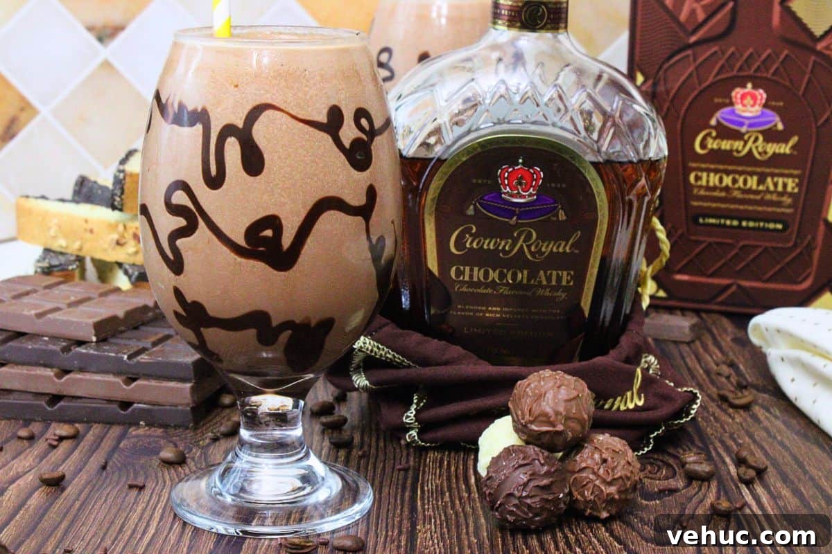 12 Irresistible Chocolate Crown Royal Cocktails to Try Tonight 8 chocolate mudslide with chocolate drizzle in the glass next to chocolate crown royal bottle and chocolate candies