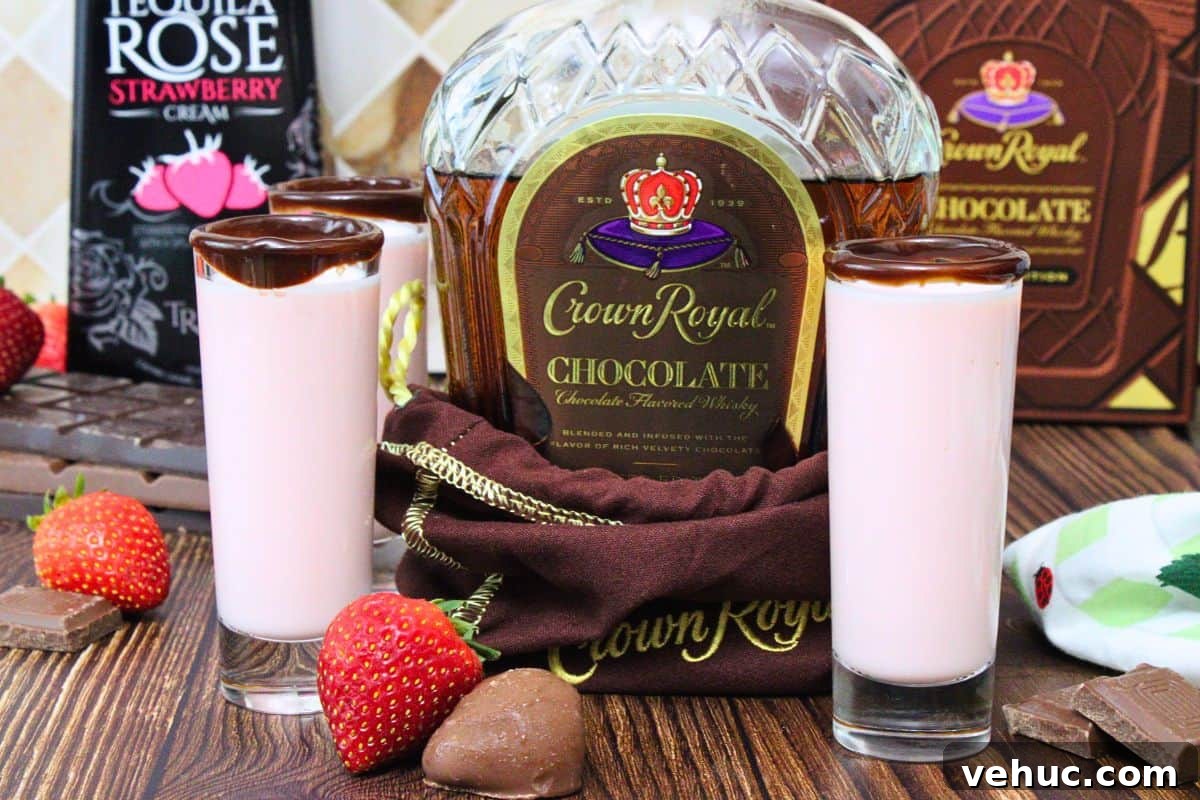 12 Irresistible Chocolate Crown Royal Cocktails to Try Tonight 9 chocolate crown royal bottle surrounded by chocolate covered strawberry shots with a chocolate rim