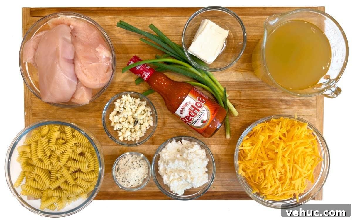 Slow-Cooker Buffalo Chicken Mac and Cheese Recipe 4 Crockpot Buffalo Chicken Mac and Cheese ingredients shot on a board