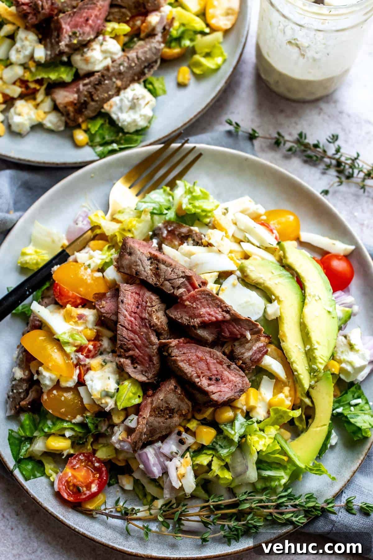 Grilled Steak Salad with Balsamic Vinaigrette Recipe 5 Steak House Salad on a white plate with herbs