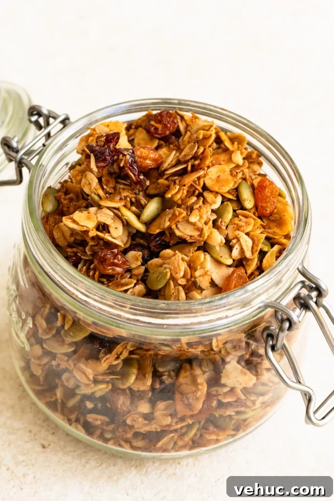 Glass canister filled with baked granola. 