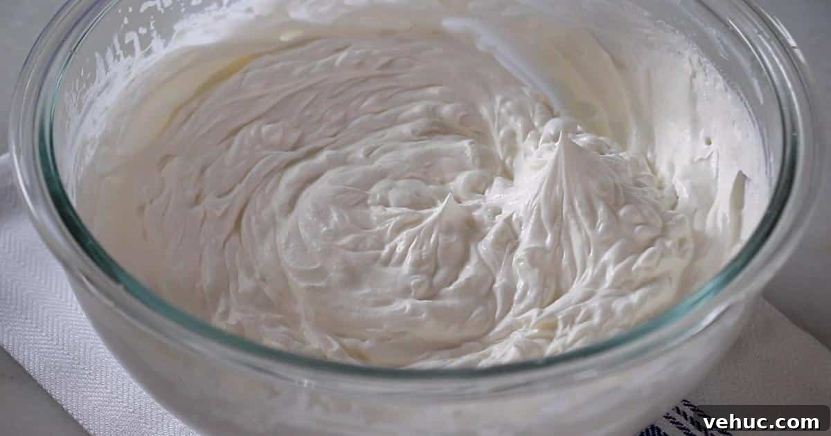Authentic Tres Leches Cake Recipe: Moist Latin-Style Dessert 10 whipped cream in a bowl