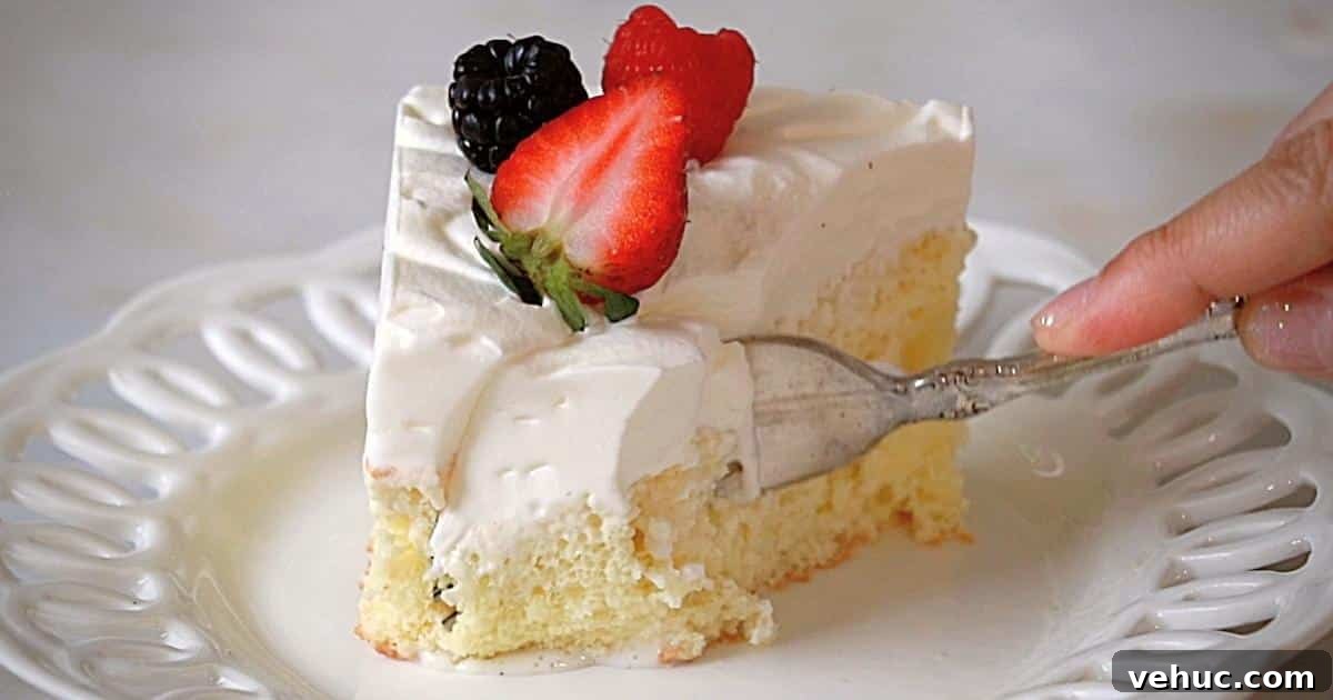 Authentic Tres Leches Cake Recipe: Moist Latin-Style Dessert 11 cutting tres leches cake on a white plate with a fork