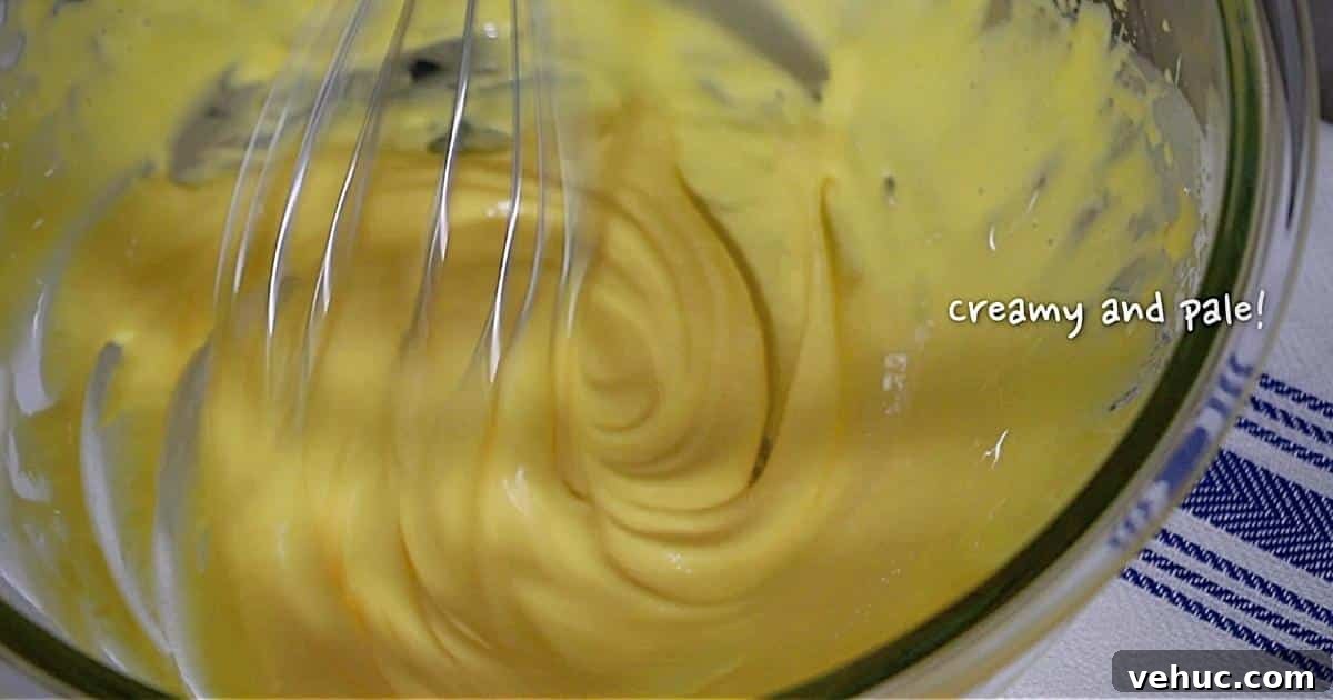 Authentic Tres Leches Cake Recipe: Moist Latin-Style Dessert 8 whipped yolks in a bowl