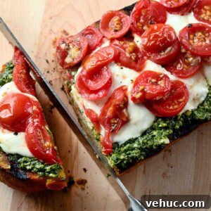 Grilled Pesto Bread with Burrata and Roasted Tomatoes 2 Grilled bread topped with pesto, burrata and tomatoes