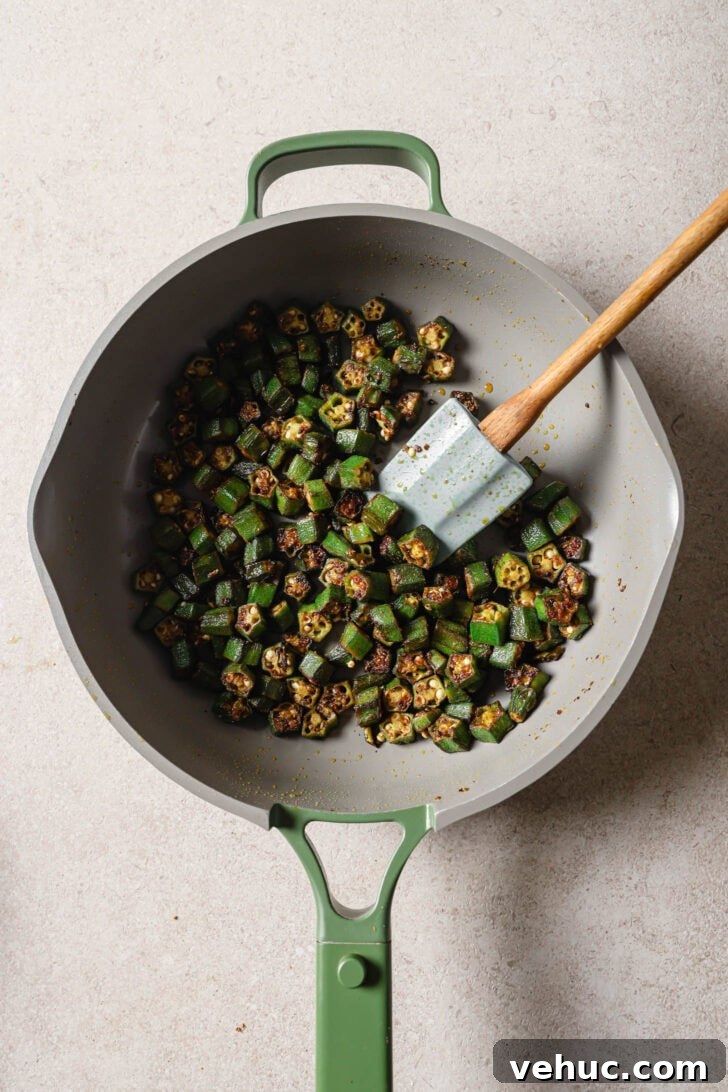 15-Minute Indian-Style Bhindi Fry Recipe for Crispy Okra 11 Bhindi Fry in a skillet with a spatula.