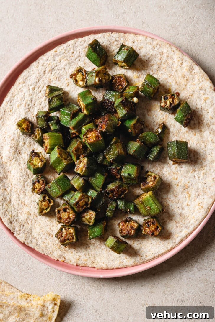 15-Minute Indian-Style Bhindi Fry Recipe for Crispy Okra 3 Bhindi Fry on top of roti.
