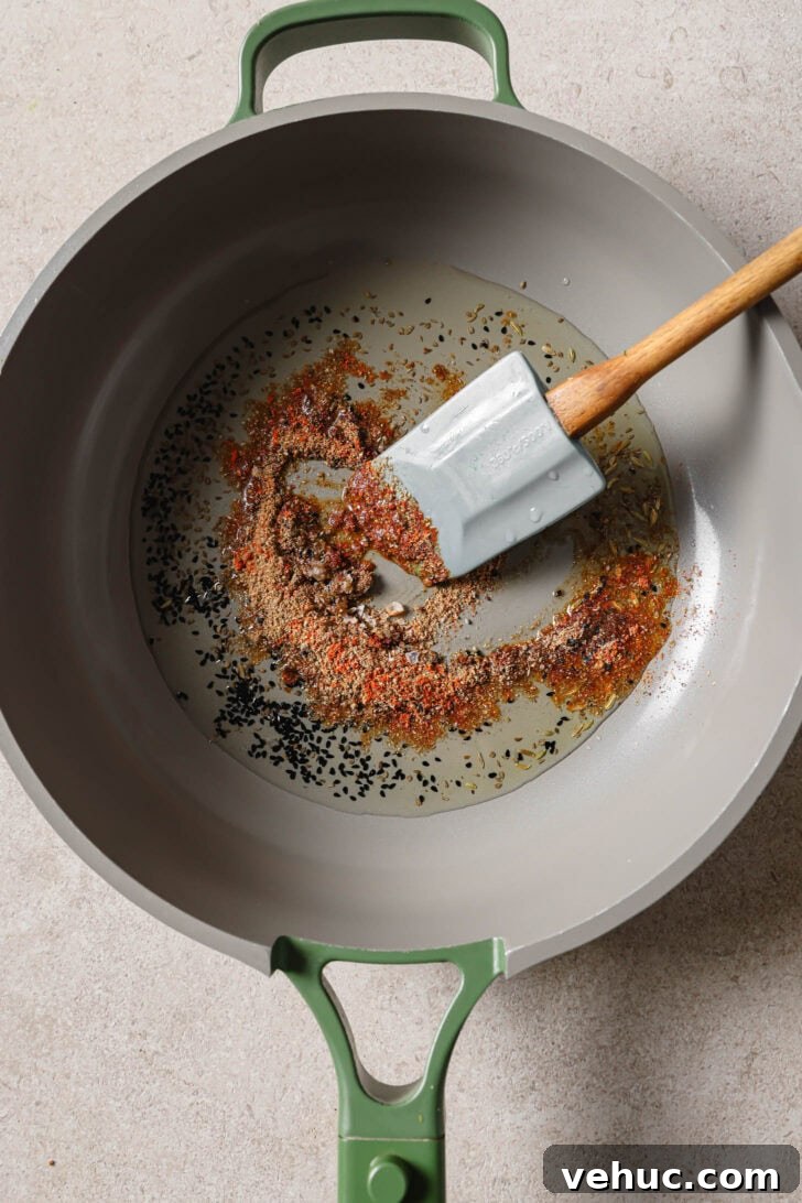 15-Minute Indian-Style Bhindi Fry Recipe for Crispy Okra 6 Ground spices added to pan with sauteéd carom seeds and nigella seeds