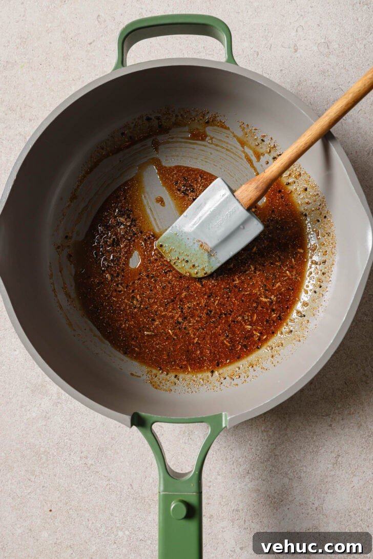 15-Minute Indian-Style Bhindi Fry Recipe for Crispy Okra 7 Blooming ground spices in a skillet to make Bhindi Fry.