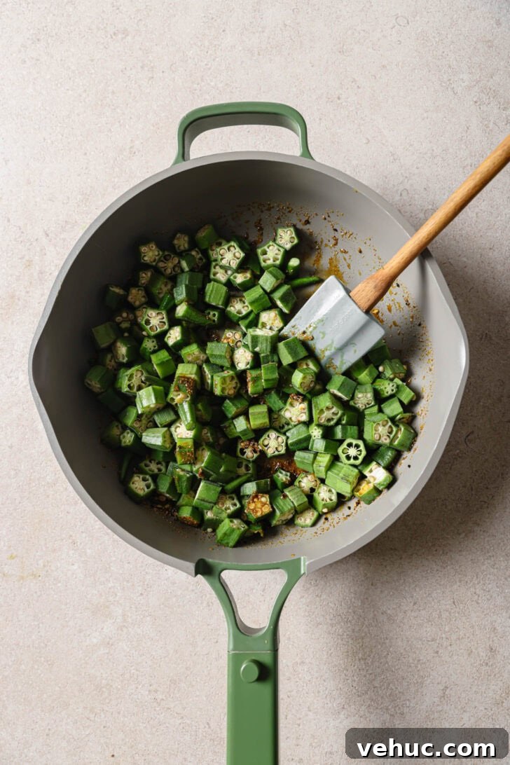 15-Minute Indian-Style Bhindi Fry Recipe for Crispy Okra 9 Sliced okra added to skillet.