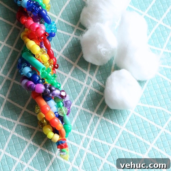 Beaded Rainbow Sun Catcher Craft for Kids: Step-by-Step Guide 5 twisted beaded pipe cleaners and cotton balls
