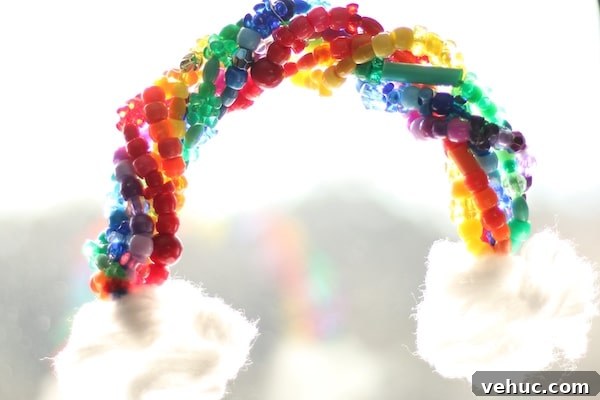 Beaded Rainbow Sun Catcher Craft for Kids: Step-by-Step Guide 7 beaded pipe cleaner rainbow hanging in window