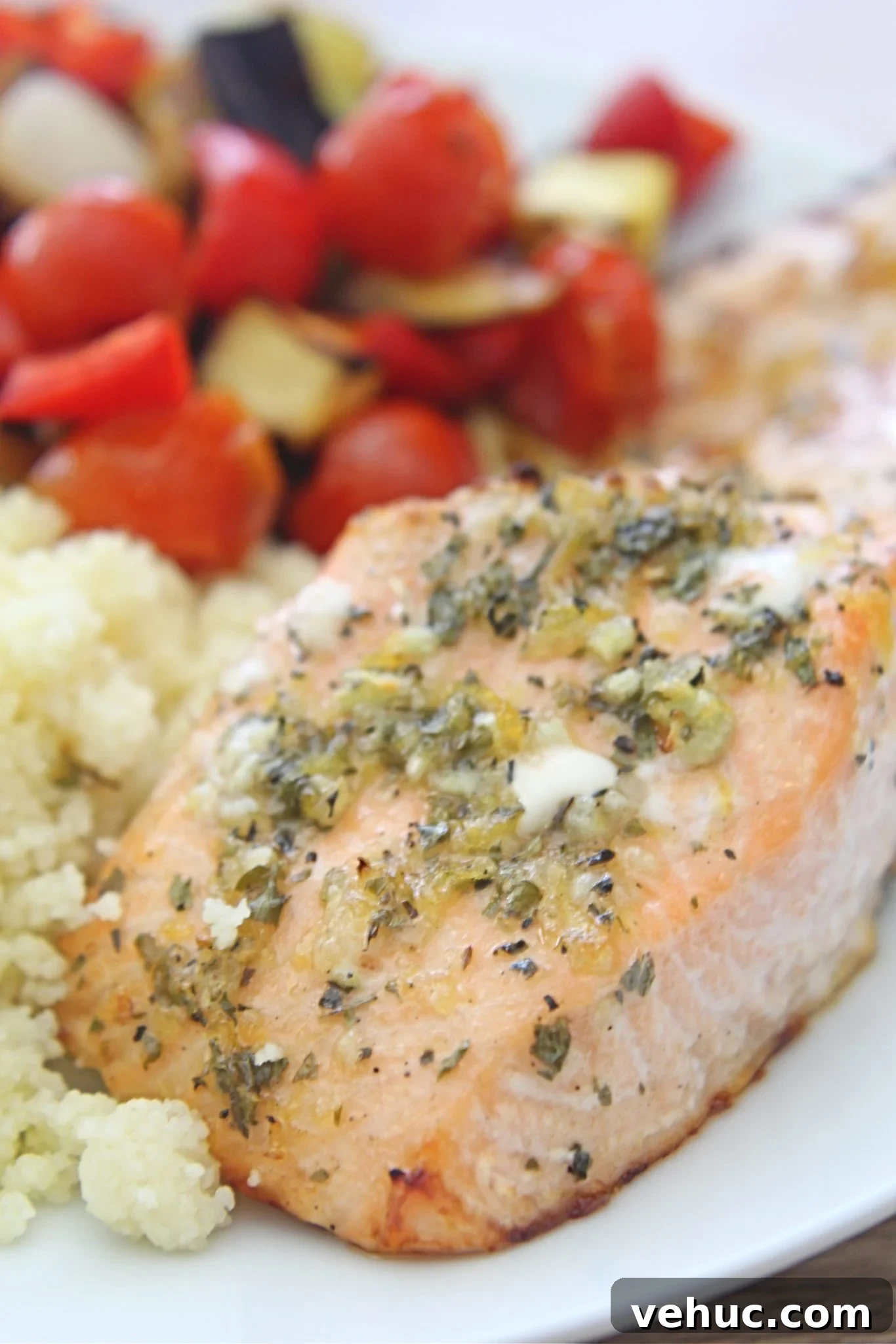 40+ 30-Minute Family Meals for Busy Weeknights 26 Lemon herb salmon with roasted vegetables and couscous on a white serving plate