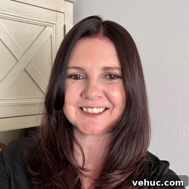 Photo of Kimberly Vargo in front of a bookcase.