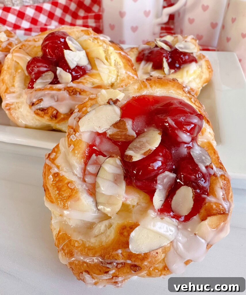 Cherry Cream Cheese Knots: Sweet Stuffed Pastry Bites for Brunch 2 Cherry Cream Cheese Knots on a white serving platter.