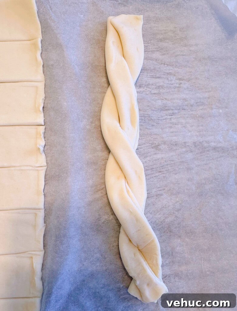 Cherry Cream Cheese Knots: Sweet Stuffed Pastry Bites for Brunch 5 Strips of puff pastry twisted together.