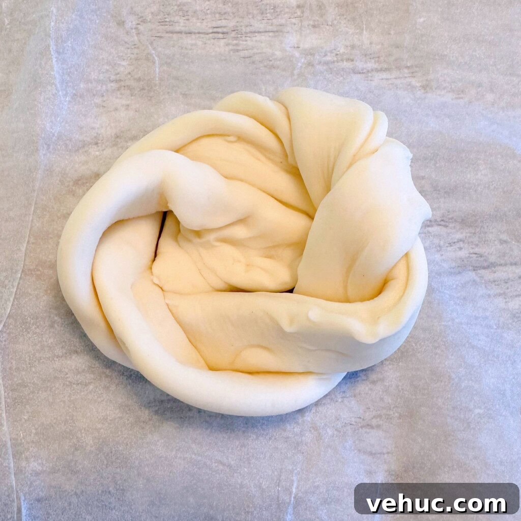 Cherry Cream Cheese Knots: Sweet Stuffed Pastry Bites for Brunch 6 Twisted Puff Pastry tied into a loose knot.
