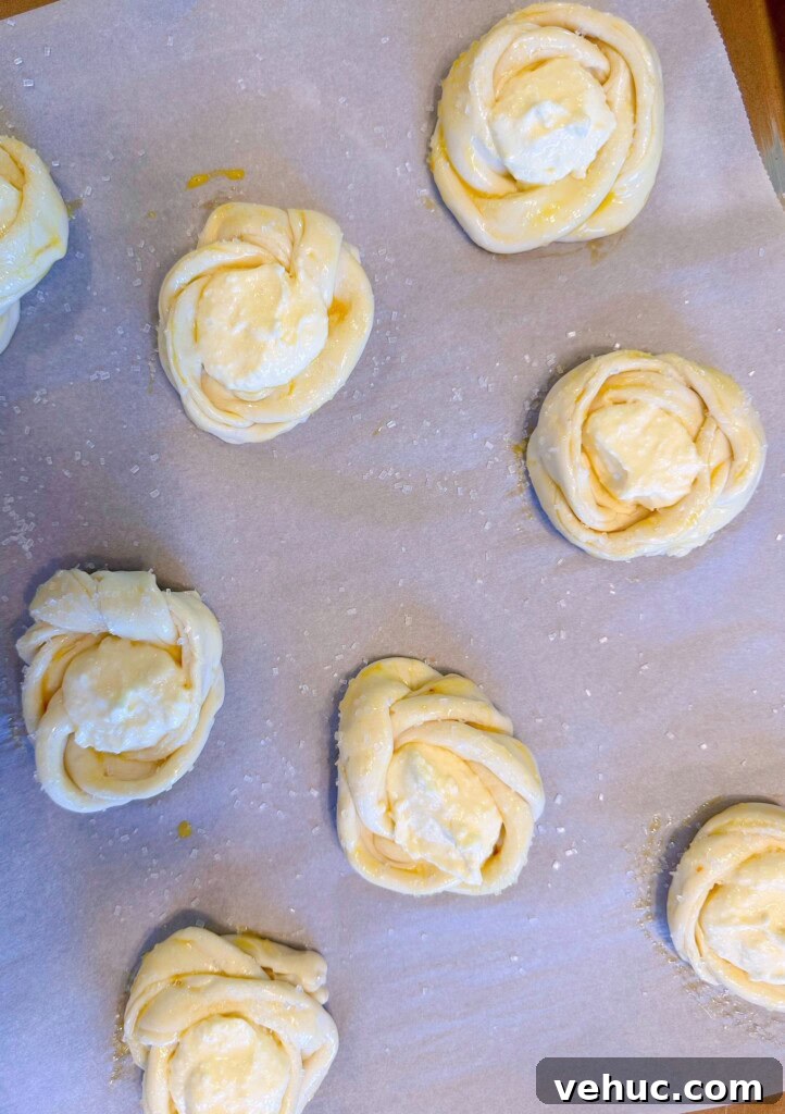 Cherry Cream Cheese Knots: Sweet Stuffed Pastry Bites for Brunch 9 Filling pastry knots with cream cheese filling.