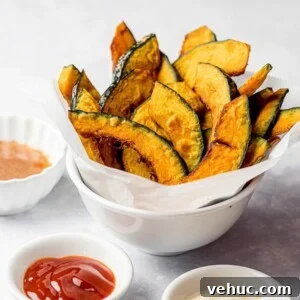 kabocha squash fries in a white bowl with ketchup and condiments