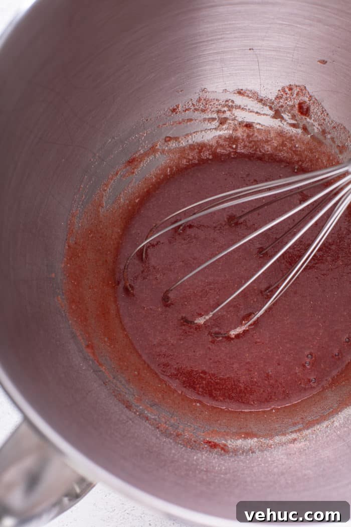 Homemade Strawberry Marshmallows: Soft, Fluffy Recipe 5 Strawberry powder, water, and gelatin mixed in a metal bowl.