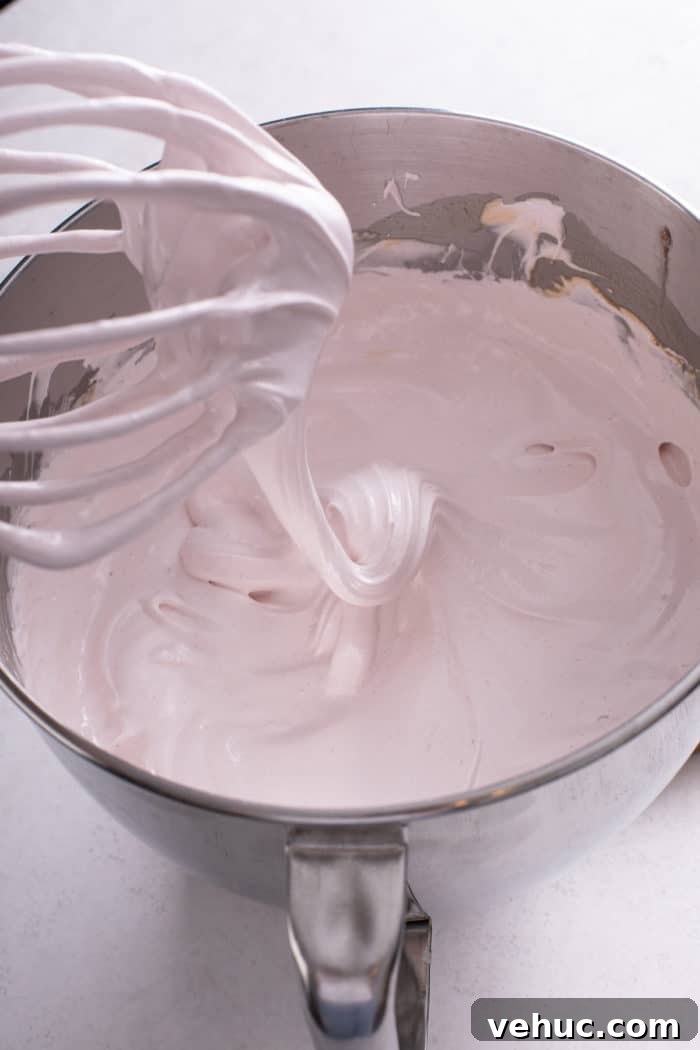 Homemade Strawberry Marshmallows: Soft, Fluffy Recipe 7 Freshly mixed strawberry marshmallow mixture in a metal mixing bowl.