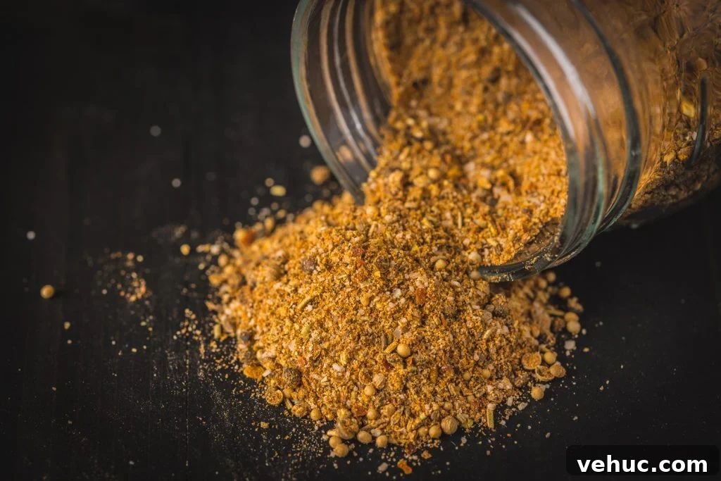 Montreal Steak Seasoning: How to Make and Use It for Perfect Steaks 6 Montreal steak seasoning pouring out of a glass bottle.