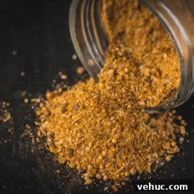 Montreal Steak Seasoning: How to Make and Use It for Perfect Steaks 7 Montreal steak seasoning pouring out of a glass bottle.