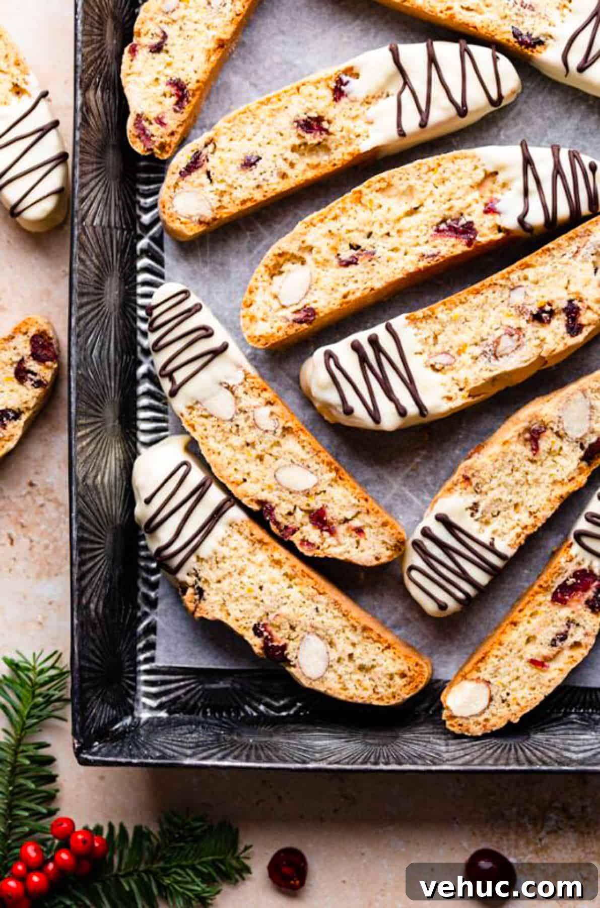 Cranberry Almond Biscotti Recipe for Crunchy Coffee Cookies 11 cranberry almond biscotti dipped in white chocolate and drizzled with more chocolate inside of the baking tin.