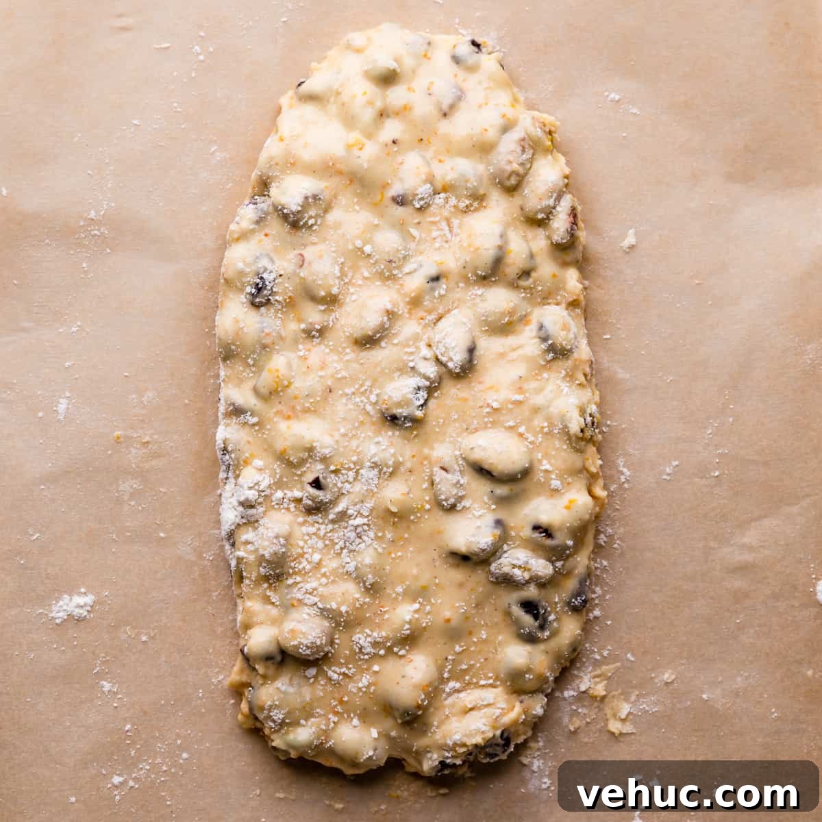 Cranberry Almond Biscotti Recipe for Crunchy Coffee Cookies 6 raw dough for cranberry biscotti shaped into flat oval on a baking paper.