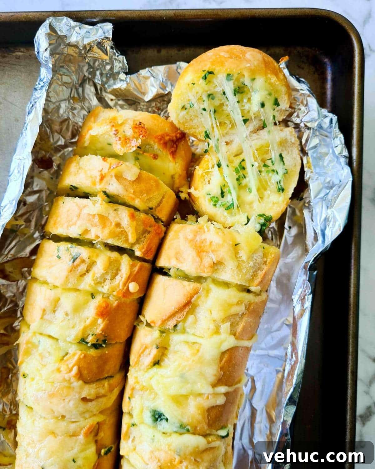 Irresistible Cheesy Garlic Bread Recipe for Perfect Crispy Loaves 2 Cheesy garlic bread straight out of the oven with visible strechy, melted cheese
