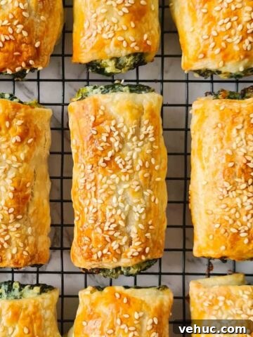 Golden spinach and ricotta rolls on a cooling rack