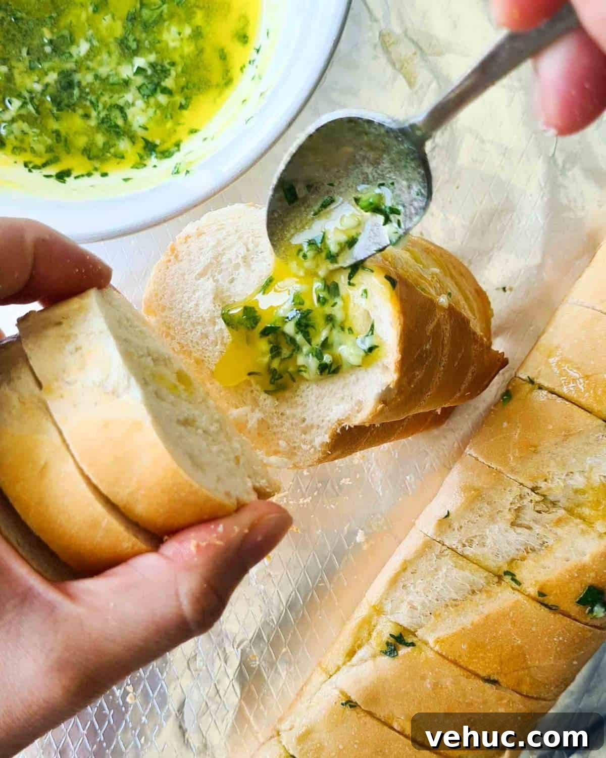 Irresistible Cheesy Garlic Bread Recipe for Perfect Crispy Loaves 8 Melted garlic butter being spooned onto a cut side of a baguette