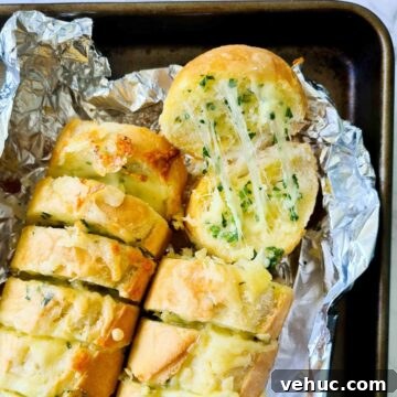 Close up of strechy cheesy garlic bread straight out of the oven