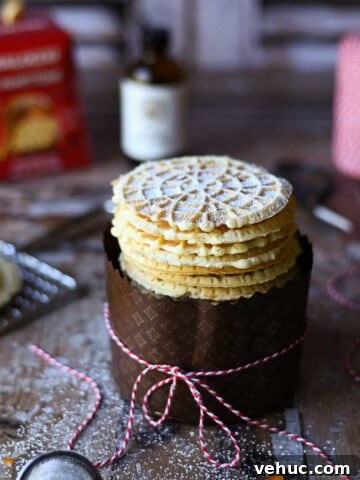 Pizzelle cookies stacked in a panetone wrapper with a bow.