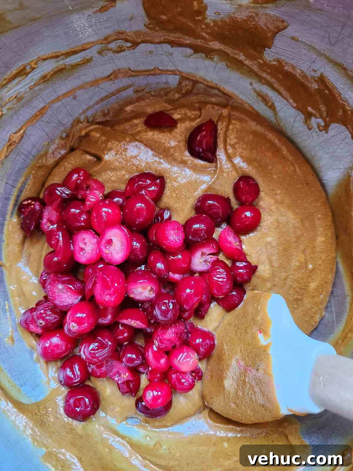 Cranberry Gingerbread Loaf Recipe with Zesty Ginger Glaze 7 Cranberries with batter in a metal bowl.