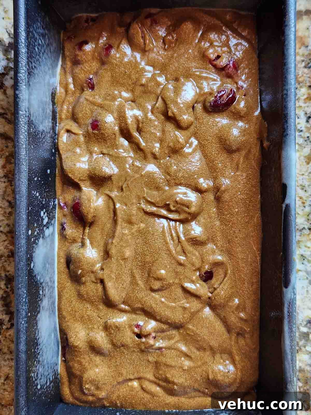 Cranberry Gingerbread Loaf Recipe with Zesty Ginger Glaze 9 Batter in a loaf pan ready for baking.