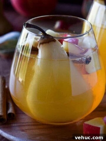 Close-up of apple and pear sangria in a glass.