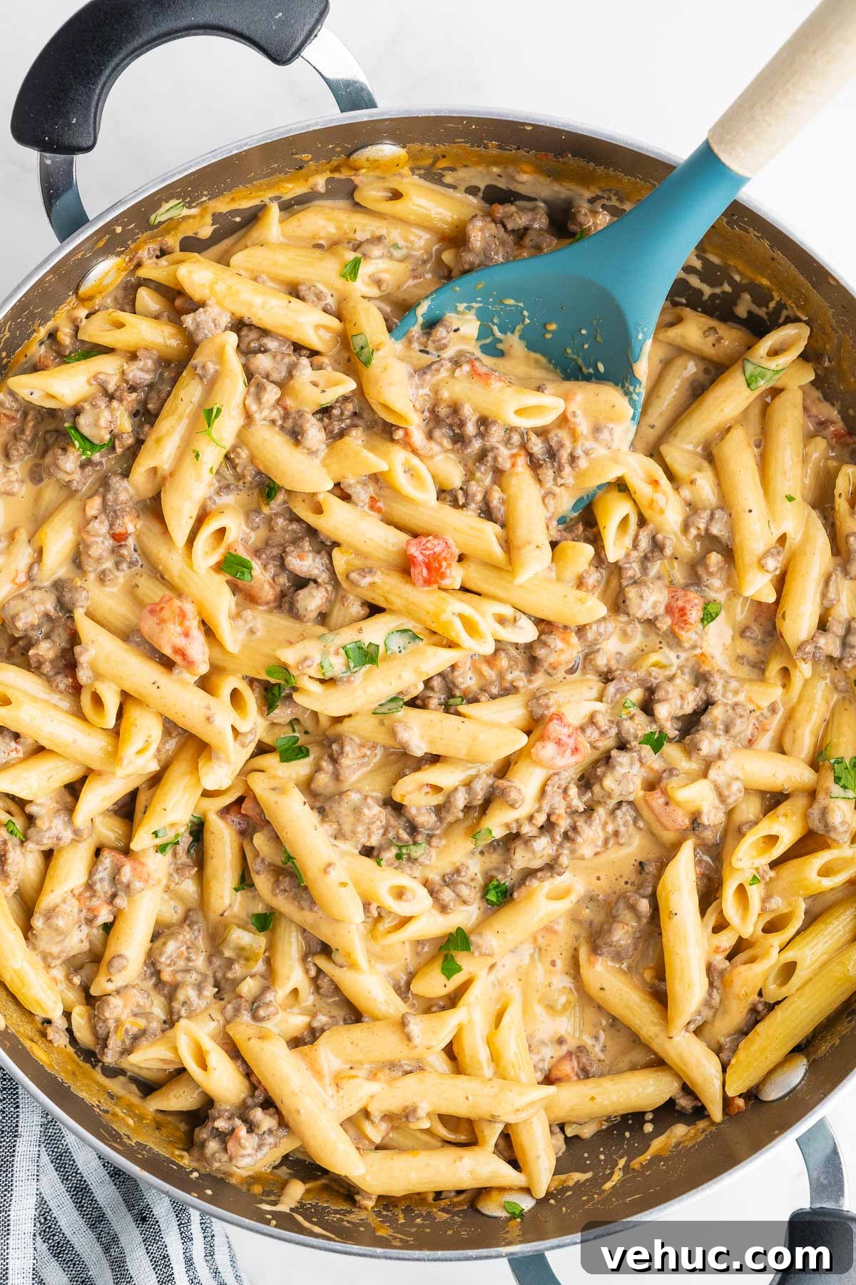 Creamy Rotel Pasta Recipe with Tomatoes and Sausage 6 Close up of tender penne mixed with ground beef and melted cheese