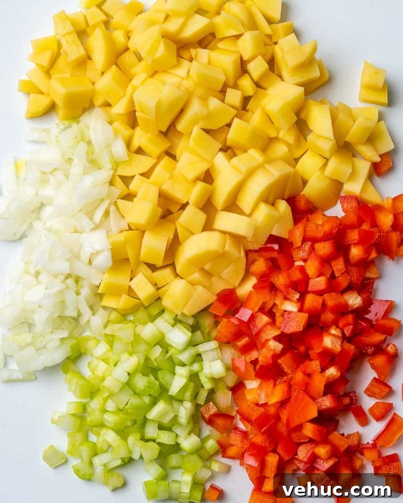 Creamy Chicken and Corn Chowder Recipe for Comforting Meals 5 Corn, peppers, celery, and onion chopped on cutting board.