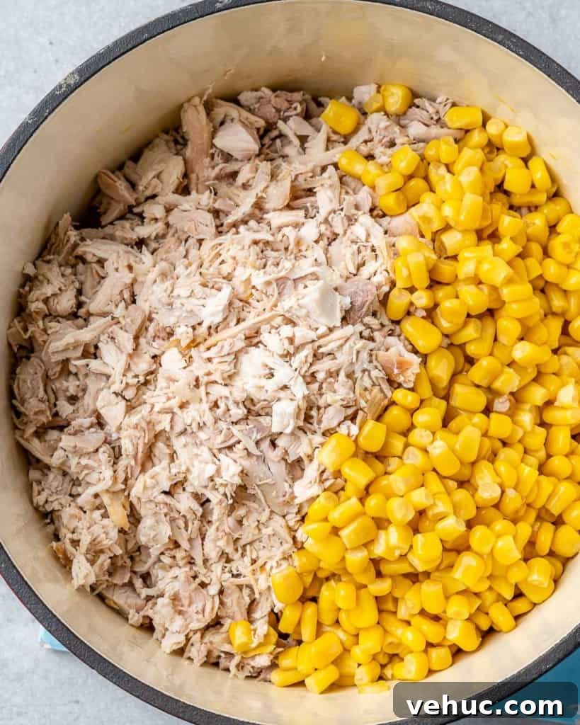 Creamy Chicken and Corn Chowder Recipe for Comforting Meals 6 Shredded turkey and corn in pot.