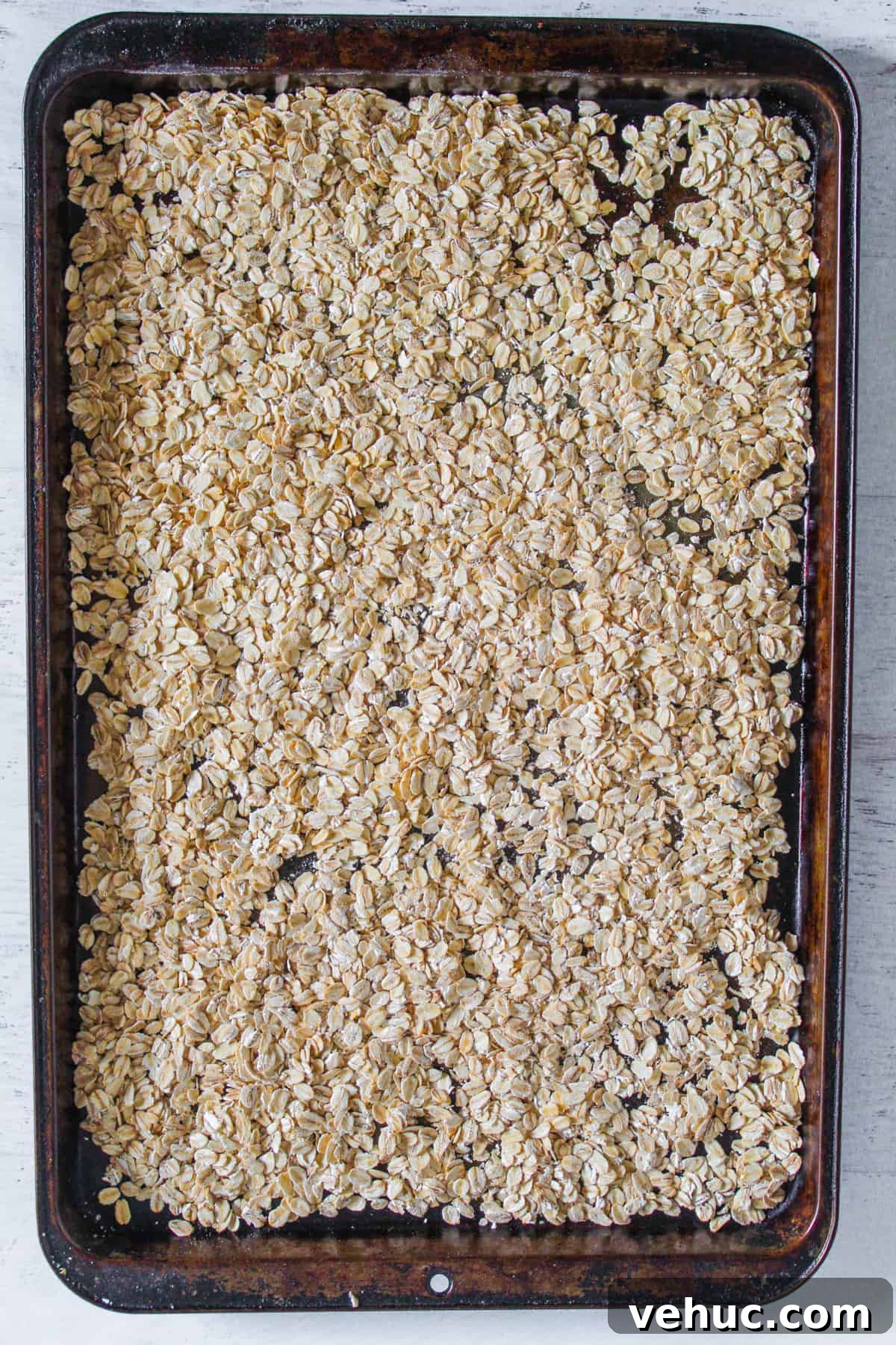 Gluten-Free Oat Bread Recipe with Vegan Option 4 toasting oats on a baking sheet