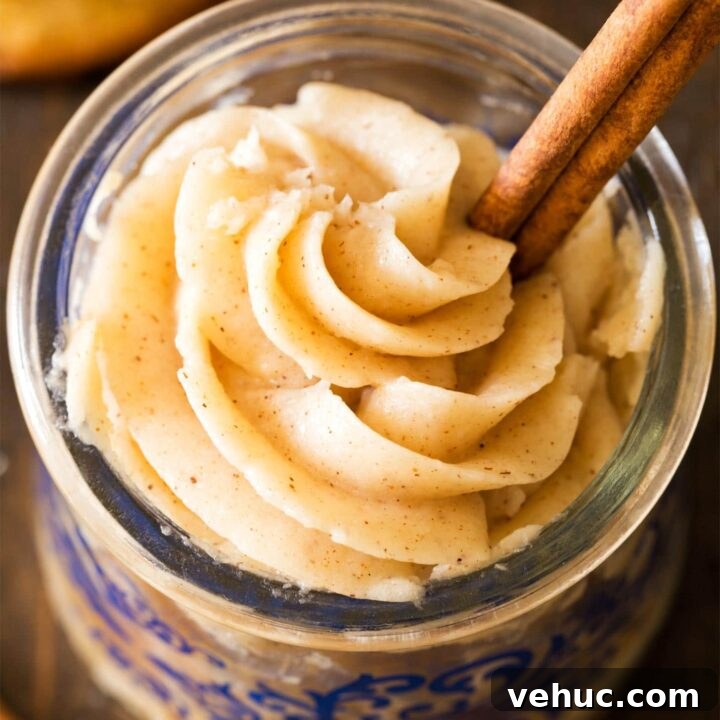 Cinnamon frosting in jar with cinnamon stick