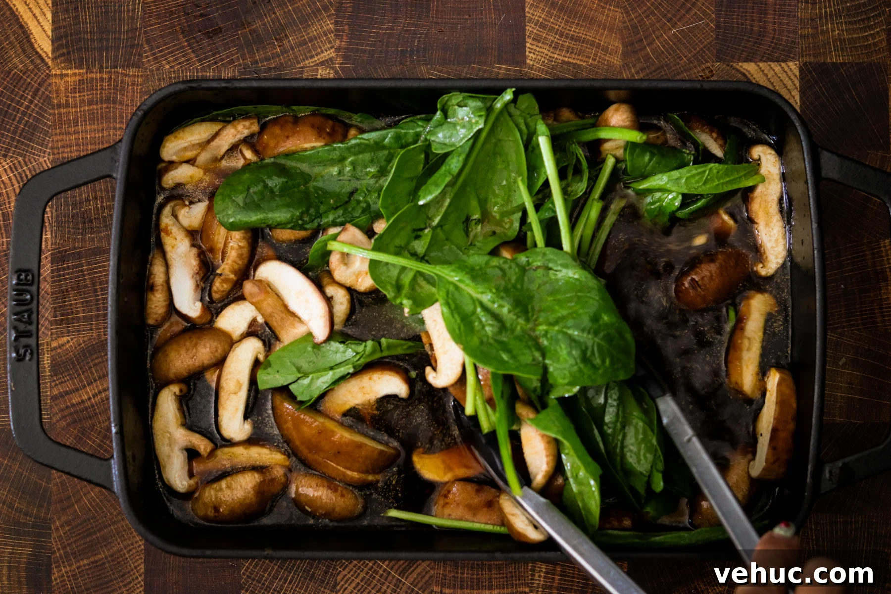 Crispy Baked Dumplings with Ramen: One-Pan Weeknight Dinner 5 Fresh mushrooms and spinach added to the gochujang broth in a baking dish.