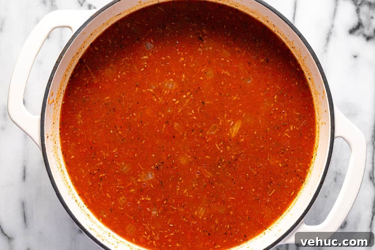 Creamy Italian Meatball Soup: Cozy Weeknight Recipe 6 Large white pot filled with ingredients to make Italian meatball soup.