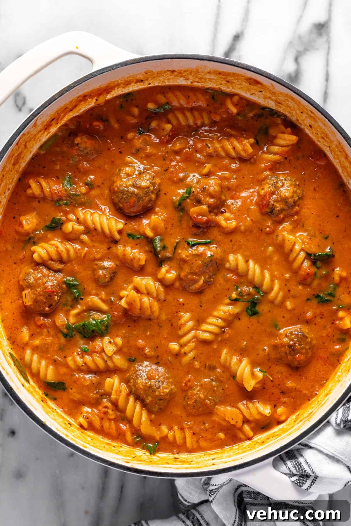 Creamy Italian Meatball Soup: Cozy Weeknight Recipe 9 Large white pot filled with creamy homemade meatball pasta soup.