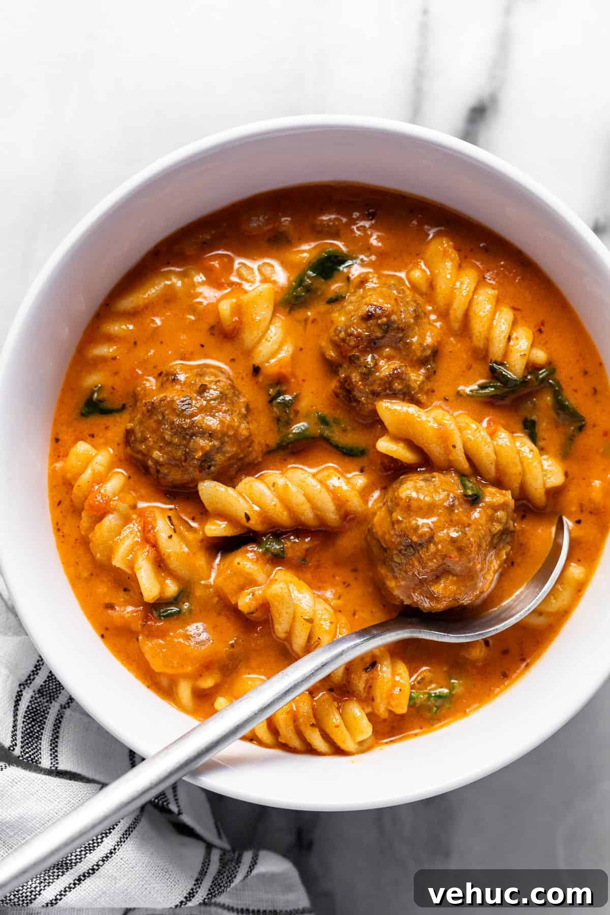 Creamy Italian Meatball Soup: Cozy Weeknight Recipe 10 White bowl filled with homemade creamy Italian meatball soup.