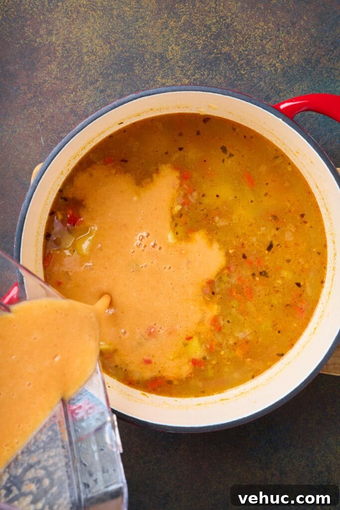 Roasted Poblano and Corn Chowder with Smoky Creaminess 9 Pouring blended soup into a pot of corn chowder