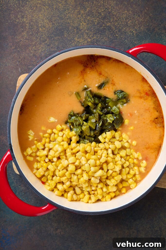Roasted Poblano and Corn Chowder with Smoky Creaminess 11 A soup pot with corn and roasted peppers